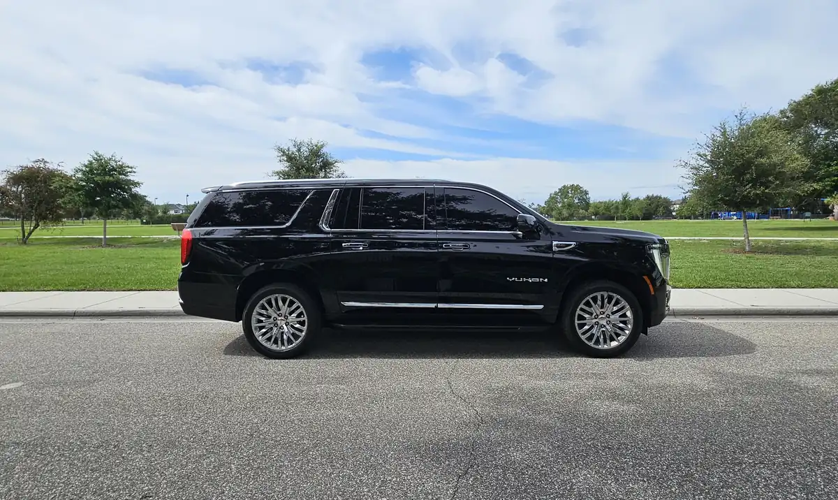 Premium black SUV car service for concert transportation side view