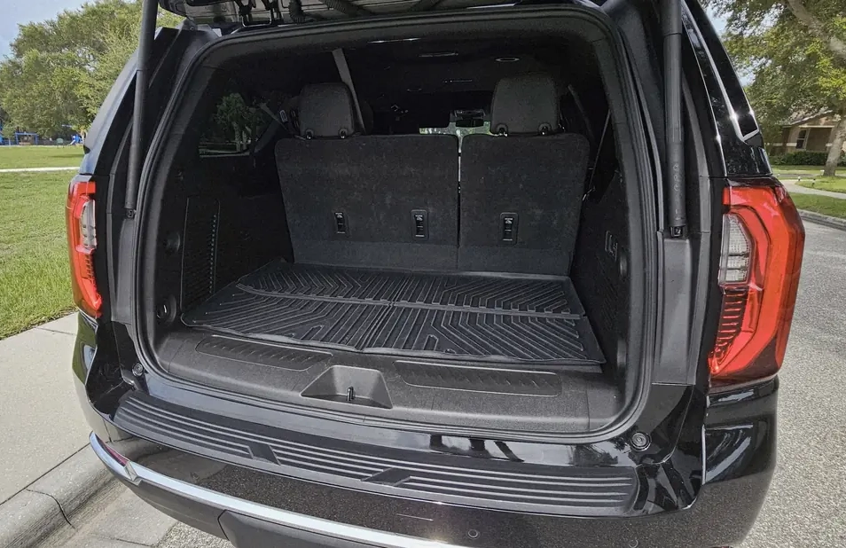 Spacious SUV trunk with ample room for airport luggage and rental strollers.