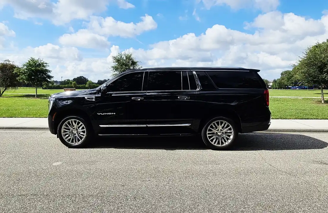 Professional black SUV car service waiting for pickup at Orlando International Airport.