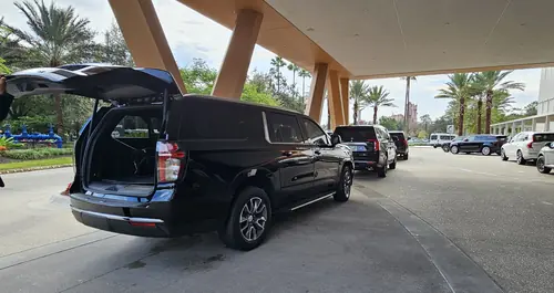 Family arriving at their Disney resort hotel in a clean Majestic SUV
