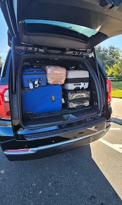 Majestic chauffeur loading luggage for a family's airport transfer
