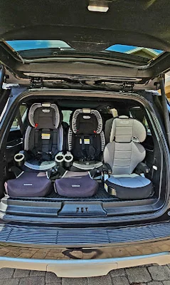 Three clean, installed car seats ready for a family in a Majestic vehicle