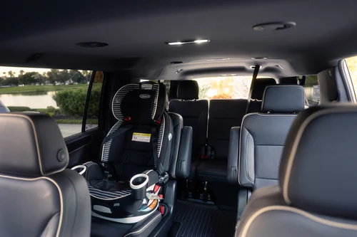 Spacious SUV with booster seats ready for a family airport transfer