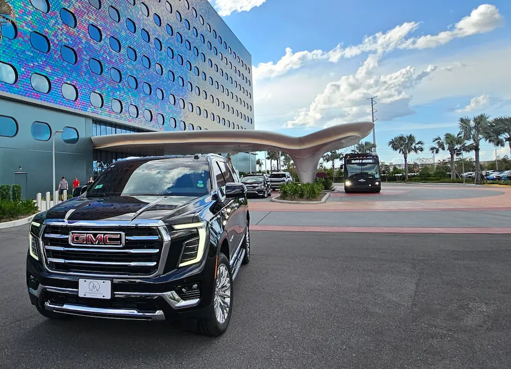 Private family friendly car service pulling up to a Disney World resort.